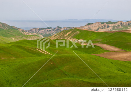 Serene rolling hills and farmland in rural mountainous region Serene rolling hills and farmland in rural mountainous region 127680152