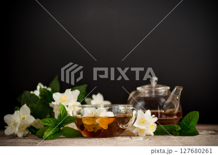 Cup with jasmine tea on a black background 127680261