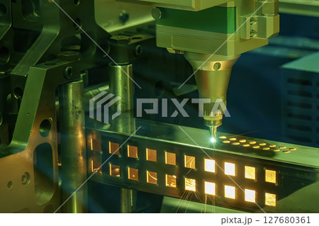 Close up scene the fiber laser cutting machine cut the square shape stainless steel tube with sparkling light. Close up scene the fiber laser cutting machine cut the square shape stainless steel tube with sparkling light. 127680361