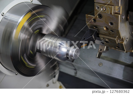 Close up scene the CNC lathe machine groove cutting the metal shaft parts. Close up scene the CNC lathe machine groove cutting the metal shaft parts. 127680362