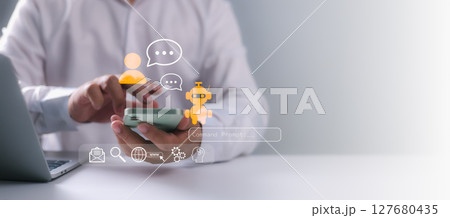 A business professional using a smartphone with chatbot AI and messaging interface icons, illustrating digital communication, virtual assistant services, automation, technology, and future innovation. A business professional using a smartphone with chatbot AI and messaging interface icons, illustrating digital communication, virtual assistant services, automation, technology, and future innovation. 127680435