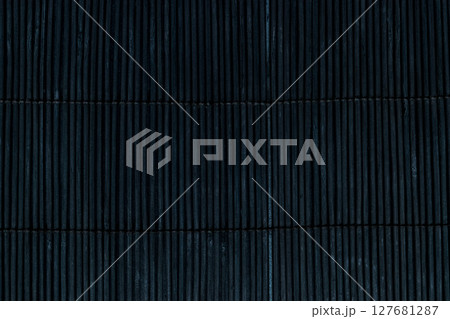 Black Bamboo Mat on Dark Background Tied Up With the Rope 127681287