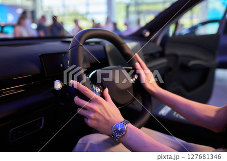 This modern car interior showcases a stylish and luxurious steering wheel and design 127681346