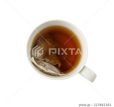 Herbal tea sachet in cup, hot water with chamomile and Hypericum or St. John's wort teabag Herbal tea sachet in cup, hot water with chamomile and Hypericum or St. John's wort teabag 127681381
