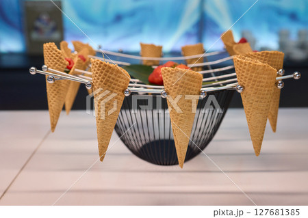 Elegant and Beautiful Dessert Presentation Featuring Ice Cream Cones Alongside Fresh Strawberries Elegant and Beautiful Dessert Presentation Featuring Ice Cream Cones Alongside Fresh Strawberries 127681385