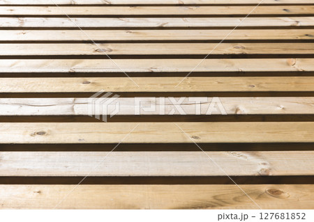Parallel wooden slats in a natural rustic finish 127681852