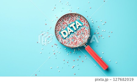 Magnifying glass focusing on word DATA among multicolored particles on blue background 127682019