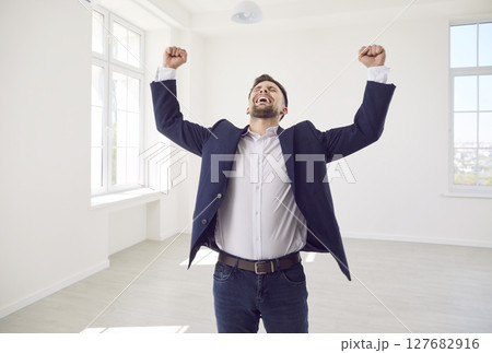 Ecstatic excited male new home owner, happy realtor after real estate deal, signing flat sale 127682916