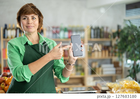 Saleswoman with a phone Saleswoman with a phone 127683180