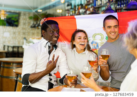 Happy friends celebrating the victory of the Peruvian team in beer bar Happy friends celebrating the victory of the Peruvian team in beer bar 127683459