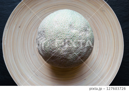 Hami Melon Fruit on Bamboo Plate Hami Melon Fruit on Bamboo Plate 127683726