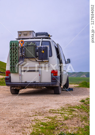 Van carrying equipment in serene rural landscape during daytime Van carrying equipment in serene rural landscape during daytime 127684002