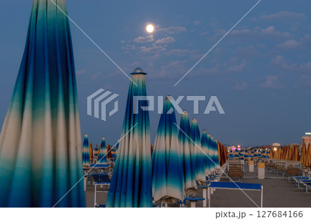 Parasols and sunbeds in Rimini resort beach 127684166