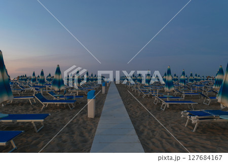 Parasols and sunbeds in Rimini resort beach 127684167