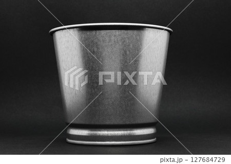 Aluminum bucket with copy space on grey background surface 127684729