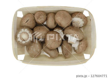 Top view of brown champignons mushrooms placed in wooden basket and isolated on white background Top view of brown champignons mushrooms placed in wooden basket and isolated on white background 127684771