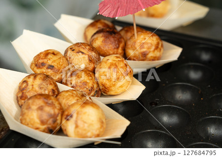 Takoyaki - traditional Japanese street food, outdoor snack with octopus Takoyaki fried balls 127684795