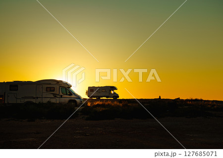 Camper cars on beach at sunset 127685071