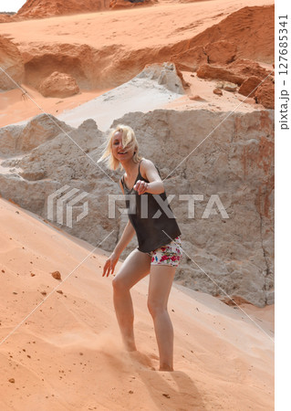 Woman walking on red sand hill in Vietnam 127685341