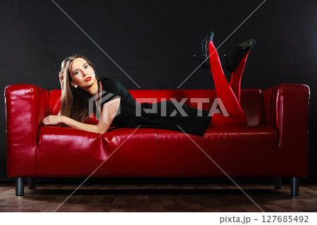Fashion woman in red pantyhose on couch Fashion woman in red pantyhose on couch 127685492