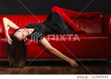 Fashion woman in red pantyhose on couch Fashion woman in red pantyhose on couch 127685493