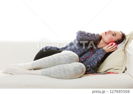 Woman with headphones listening music 127685508