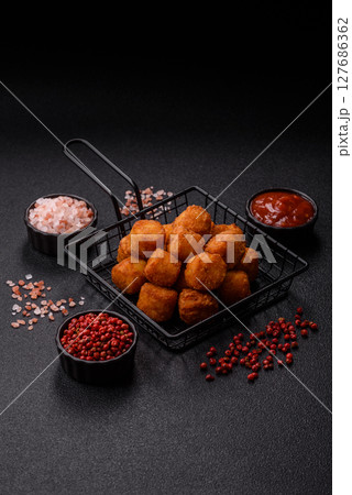 Cheese or potato croquettes, balls fried in breading with salt, spices Cheese or potato croquettes, balls fried in breading with salt, spices 127686362
