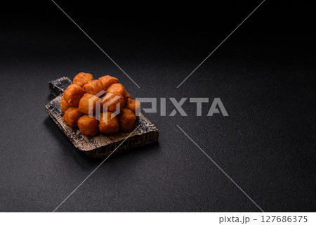 Cheese or potato croquettes, balls fried in breading with salt, spices Cheese or potato croquettes, balls fried in breading with salt, spices 127686375