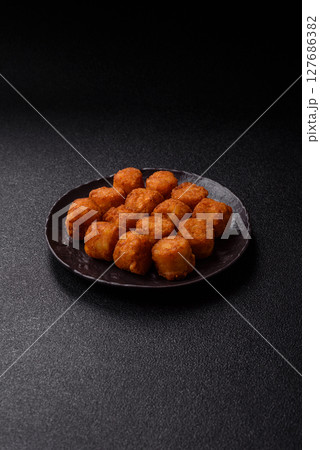 Cheese or potato croquettes, balls fried in breading with salt, spices 127686382
