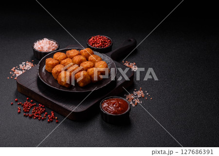 Cheese or potato croquettes, balls fried in breading with salt, spices 127686391