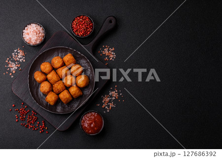 Cheese or potato croquettes, balls fried in breading with salt, spices Cheese or potato croquettes, balls fried in breading with salt, spices 127686392