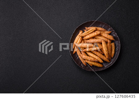 Cinnamon flavored biscuits or breadsticks Cinnamon flavored biscuits or breadsticks 127686435
