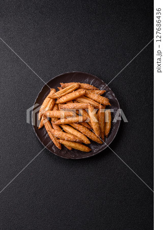 Cinnamon flavored biscuits or breadsticks 127686436