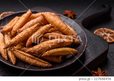 Cinnamon flavored biscuits or breadsticks 127686456