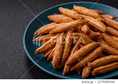 Cinnamon flavored biscuits or breadsticks 127686492