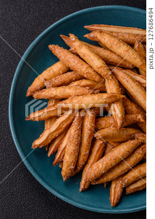 Cinnamon flavored biscuits or breadsticks 127686494