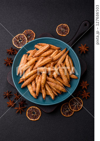 Cinnamon flavored biscuits or breadsticks 127686503