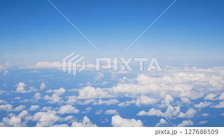 Small white clouds against the background of a blue sky, view from above 127686509