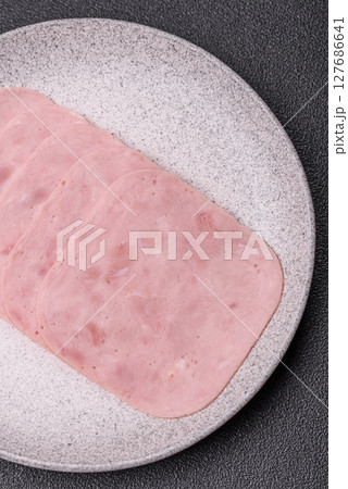 Eating ham and pork slices for the holiday table 127686641