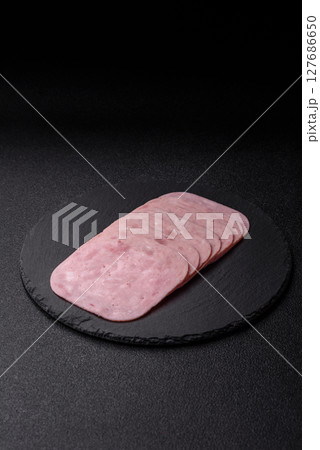 Eating ham and pork slices for the holiday table Eating ham and pork slices for the holiday table 127686650