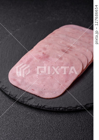 Eating ham and pork slices for the holiday table Eating ham and pork slices for the holiday table 127686654