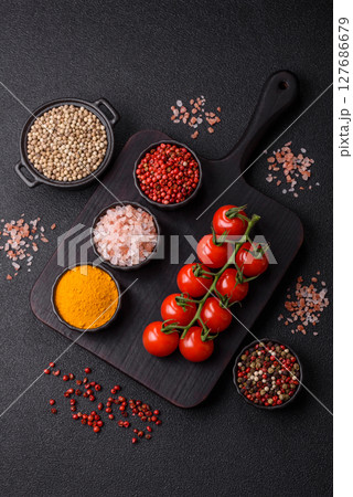 Red cherry tomatoes on a branch, a vegetable as an ingredient for making sauces Red cherry tomatoes on a branch, a vegetable as an ingredient for making sauces 127686679