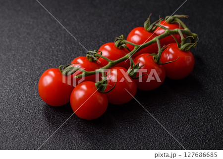 Red cherry tomatoes on a branch, a vegetable as an ingredient for making sauces 127686685