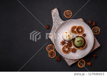 Easter sweet cake covered with icing with fruit and candied fruits 127686823