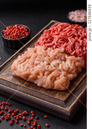Beef and chicken minced meat, ground of two types fresh raw with salt and spices Beef and chicken minced meat, ground of two types fresh raw with salt and spices 127686838