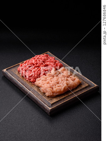 Beef and chicken minced meat, ground of two types fresh raw with salt and spices Beef and chicken minced meat, ground of two types fresh raw with salt and spices 127686846