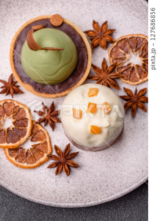 Easter sweet cake covered with icing with fruit and candied fruits 127686856