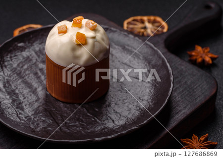Easter sweet cake covered with icing with fruit and candied fruits 127686869