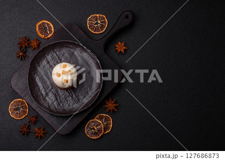 Easter sweet cake covered with icing with fruit and candied fruits 127686873