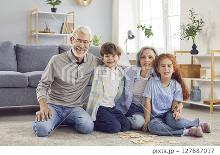 Loving elderly senior and grandchildren at home, grandmother, grandfather family have fun Loving elderly senior and grandchildren at home, grandmother, grandfather family have fun 127687017